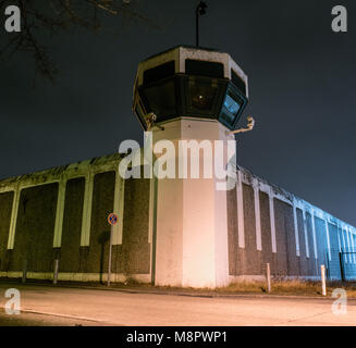 15 March 2018, Germany, Berlin: Lights brighten the wall of the Ploetzensee Prison in the evening. (long time exposure) Photo: Paul Zinken/dpa Stock Photo