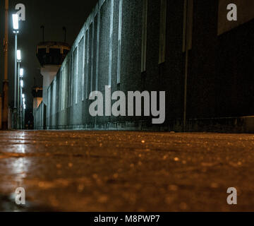15 March 2018, Germany, Berlin: Lights brighten the wall of the Ploetzensee Prison in the evening. (long time exposure) Photo: Paul Zinken/dpa Stock Photo