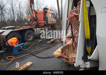 20 March, Germany, Boppard: Recovery workers attempt to right a juggernaut carrying beef which overturned on the Autobahn 61 (A61) motorway near Boppard. The motorway had to be completely closed for several hours. Photo: Thomas Frey/dpa Stock Photo