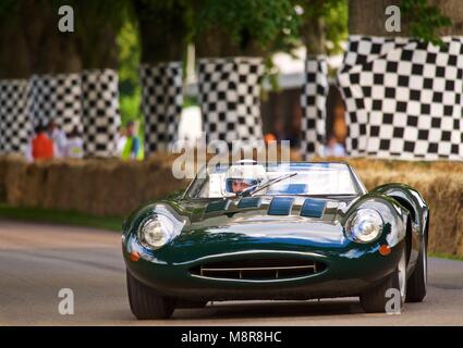 Green Historic Jaguar XJR13 race car on tree lined road Goodwood festival of speed 2011 Stock Photo