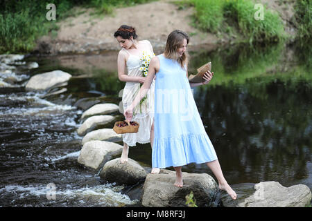 https://l450v.alamy.com/450v/m8rf3j/beautiful-girls-in-dresses-on-the-river-m8rf3j.jpg