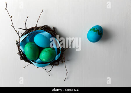 Colored blue easter eggs in twig nest. Happy easter concept. Greeting card Stock Photo