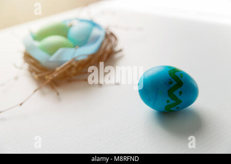 Colored blue easter eggs in twig nest. Happy easter concept. Greeting card Stock Photo