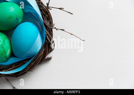 Colored blue easter eggs in twig nest. Happy easter concept. Greeting card Stock Photo