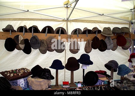 hats on display on a clothing stall at a local weekly market in skibbereen, west cork, ireland. Stock Photo