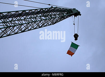 crane arm, jib flying the ireland national flag on st patricks day.Skibbereen, west cork, ireland Stock Photo