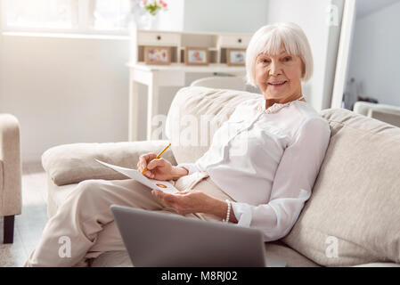Cheerful senior woman working on her business project Stock Photo