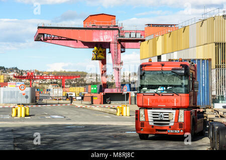 Gennevilliers, France - March 11, 2018: A red semi-trailer truck parked near the road access to the intermodal terminal in the Gennevilliers port, fir Stock Photo