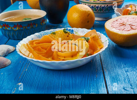 Moroccan cuisine,  Carrot Salad with Oranges and Medjool Dates, Traditional assorted Moroccodishes, Top view. Stock Photo