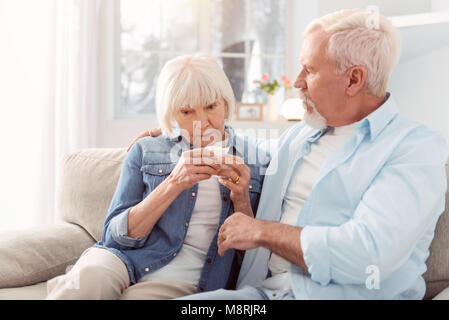 Caring elderly man consoling his crying wife Stock Photo