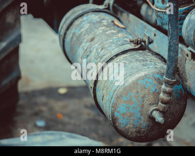 old tractor in blue rusty with details of motor engine and tools Stock Photo