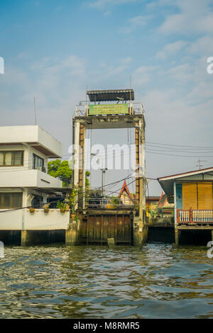 BANGKOK, THAILAND - FEBRUARY 09, 2018: Outdoor view of stoned structure with some buildings at yai canal or Khlong Bang Luang Tourist Attraction in Thailand Stock Photo