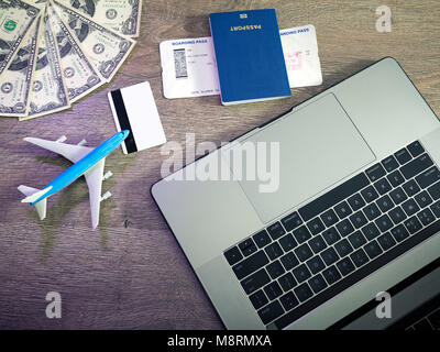 Buying airline tickets online with credit cards on table background Stock Photo