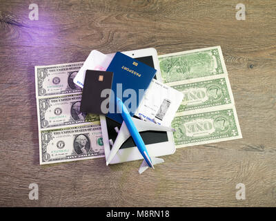 travel concept with tablet, credit cards and flight tickets on dark table Stock Photo