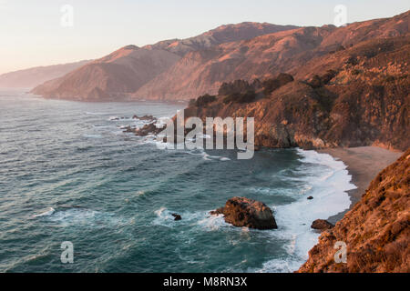 Scenic view of mountains by sea against sky during sunset Stock Photo