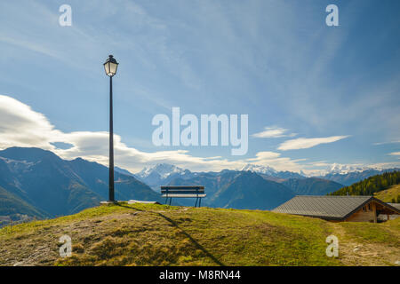 Lamp, bench a small hut in Swiss Alps. Ideal place to sit and enjoy the views Stock Photo