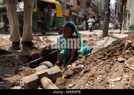 New Delhi, India: an Indian woman works on the renovation of sewers in the city of New Delhi Stock Photo