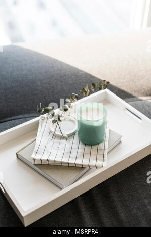 Close-up of twigs in vase on diary by candle Stock Photo