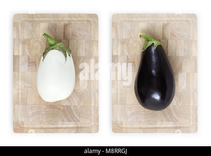 white and black eggplants on wooden cutting board food top view isolated on white Stock Photo