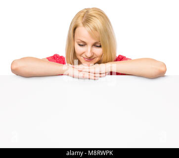 Portrait of happy smiling young woman, showing empty blank signboard with copyspace. Businesswoman holding big white banner, isolated on white backgro Stock Photo