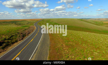 This curvy road cuts through uncultivated land in Eastern Washington Western United States Stock Photo