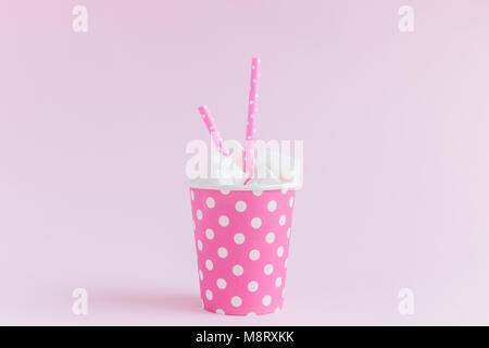 Paper cup polka design full of sugar cubes with drinking straws and ...