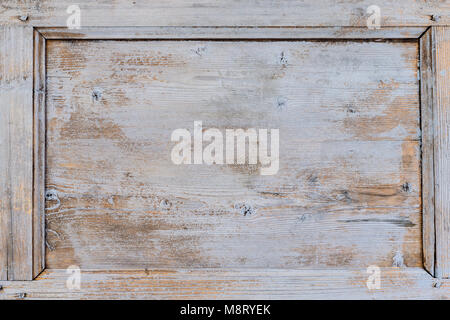 Old weathered brown door with cracked white paint background texture Stock Photo