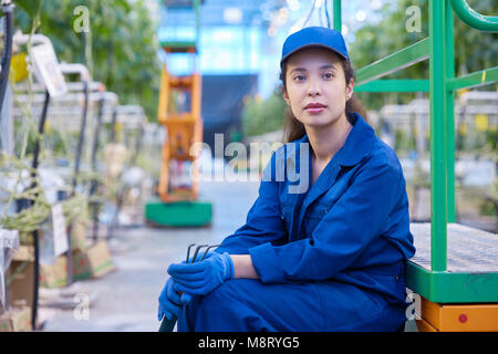 Female Worker on Break in Plantation Stock Photo
