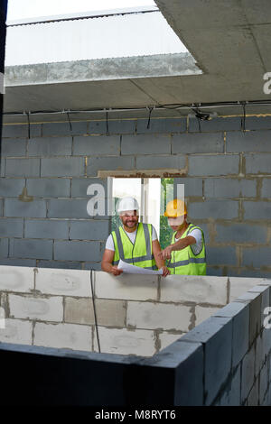 Cheerful Construction Workers on Site Stock Photo