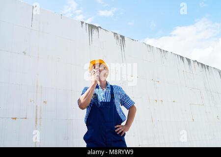 Construction Worker Using Portable Radio Stock Photo