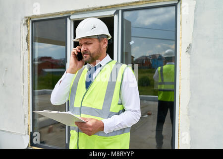 Construction Supervisor Speaking by Phone Stock Photo