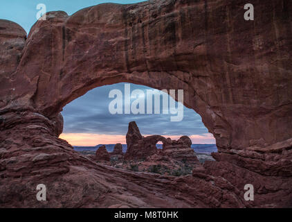 Turret arch viewed through Windows Arch in Arches National Park, Utah. Stock Photo