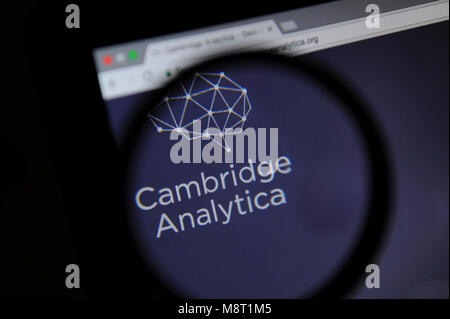 The Cambridge Analytica website is seen through a magnifiying glass Stock Photo