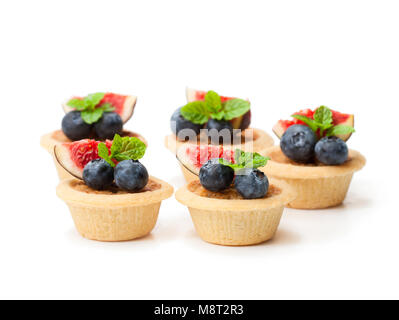 egg  custard tarts with fig slices and blueberry isolated on white Stock Photo