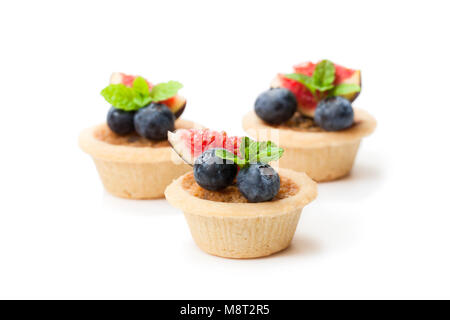 egg  custard tarts with fig slices and blueberry isolated on white Stock Photo