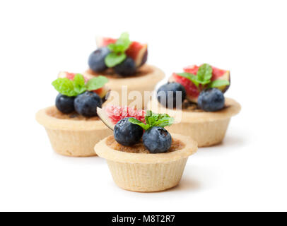 egg  custard tarts with fig slices and blueberry isolated on white Stock Photo