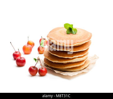 Stack  of scotch pancakes with fresh wild apples isolated on white Stock Photo
