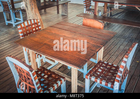 wooden table and four chairs - empty restaurant  - Stock Photo