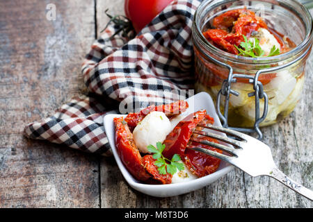 Sun  dried tomatoes with mozzarella in glass jar Stock Photo