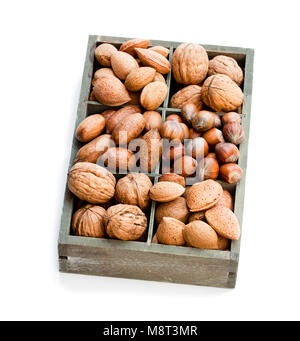 Various  nuts in wooden box isolated on white Stock Photo