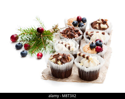 Chocolate  mini cupcakes with christmas decoration isolated on white Stock Photo
