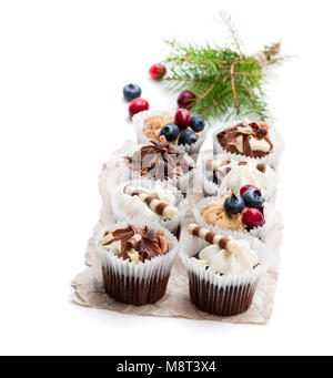 Chocolate  mini cupcakes with christmas decoration isolated on white Stock Photo