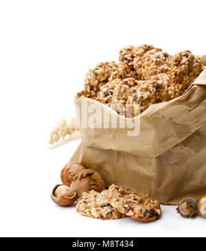 Healthy  protein granola crackers with seeds and nuts in paper bag isolated on white Stock Photo