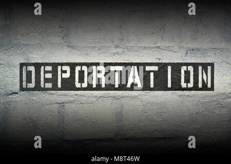 deportation stencil print on the grunge white brick wall Stock Photo