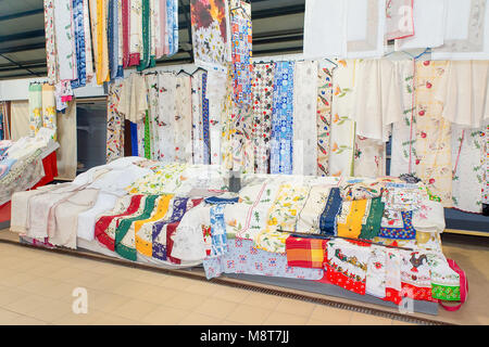 Many spread textiles and fabrics for sale at market Stock Photo