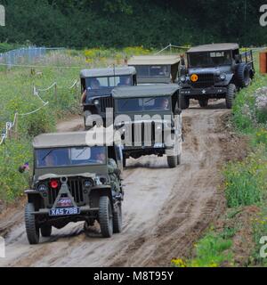 Four Willys Jeeps leading a Dodge M37 ¾ ton truck at 2017 War and Peace Revival at Hop Farm near Paddock Wood, Kent, UK. Stock Photo