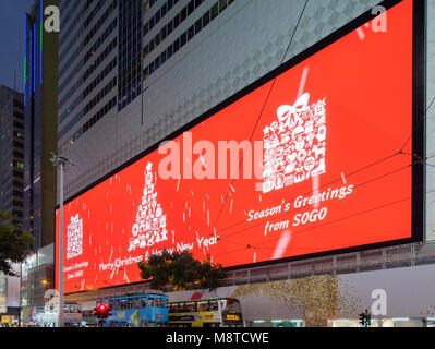 Screen displaying Christmas greetings. Sogo Mall, Hong Kong, Hong Kong. Architect: Mitsubishi Electric, 2017. Stock Photo