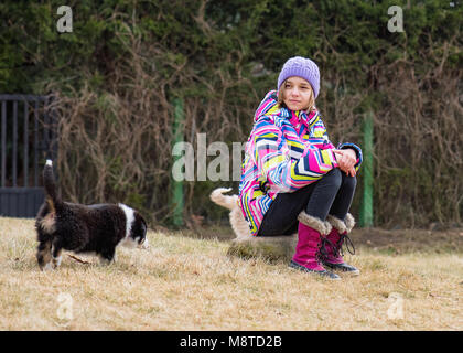 Teen girl playing with puppy Stock Photo