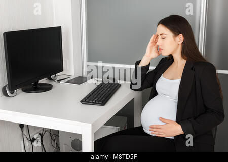 pregnant woman in the office Stock Photo