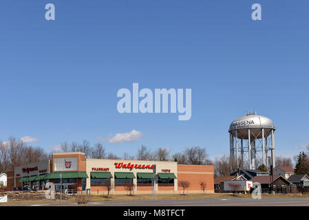 Massena, NY, USA - April 12, 2014:  Walgreens, on Main Street, is the second largest pharmacy chain in the US.  The village water tower is to the righ Stock Photo